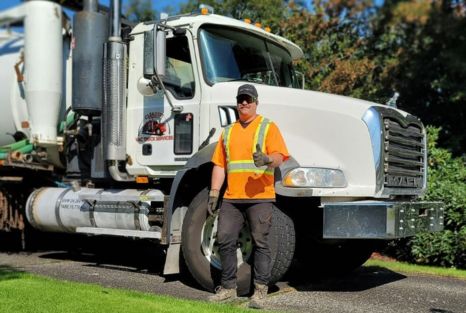 Clearset crew member in PPE beside the service truck.