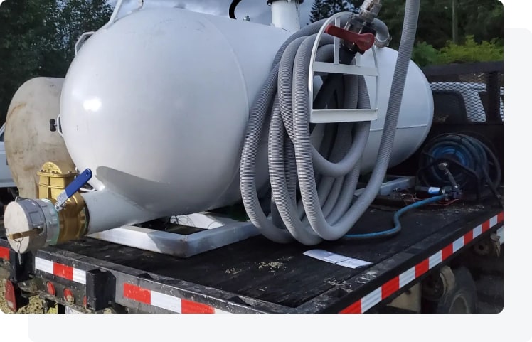 Technician checking septic access hardware during a residential visit.