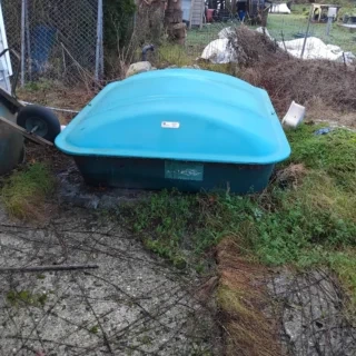 Septic tank access lid and treatment hardware visible in a Surrey-area yard before troubleshooting work begins.